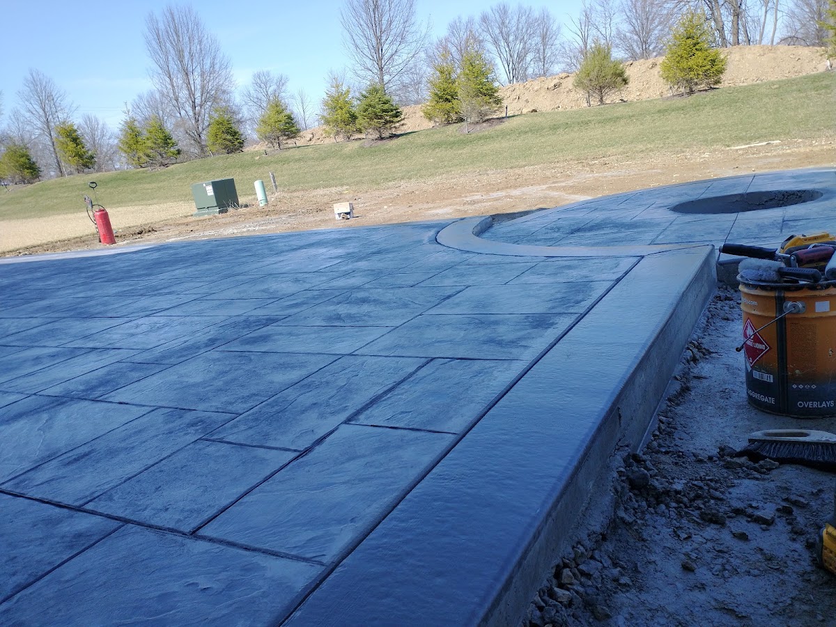 Large stamped and blue-stained concrete patio